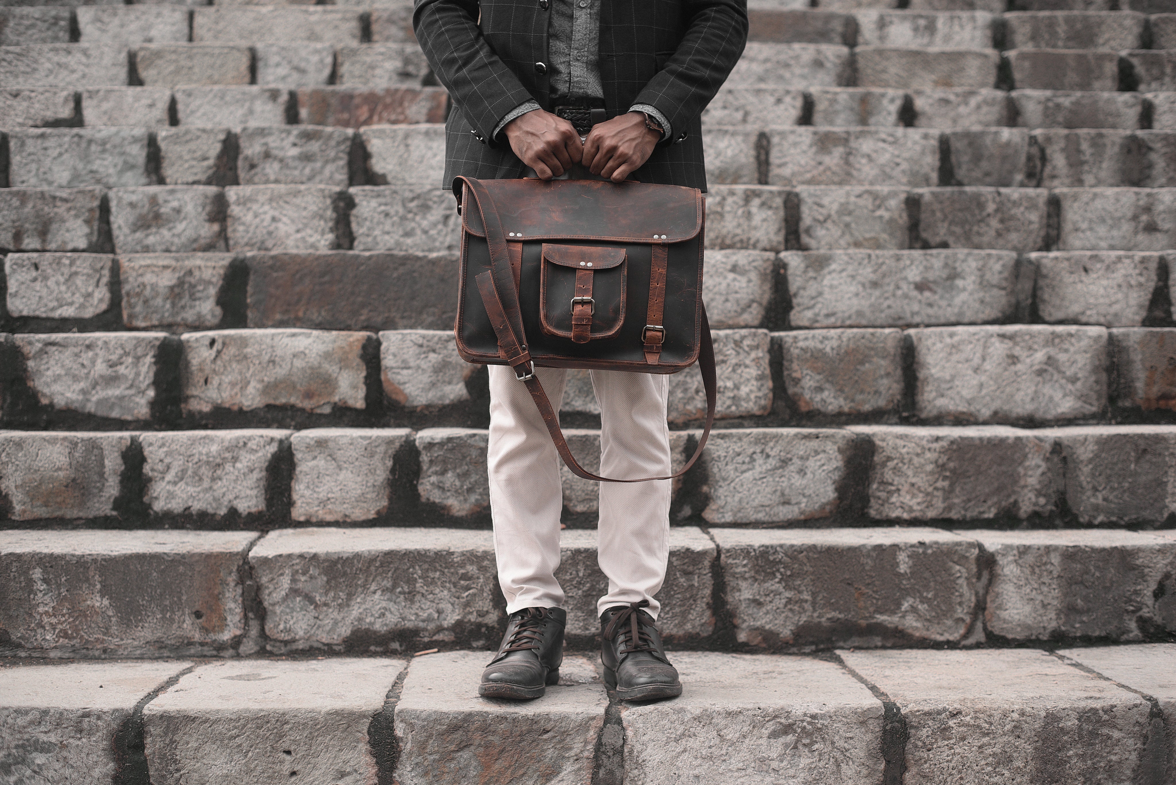 files/man-holding-a-leather-bag-on-a-set-of-stairs.jpg