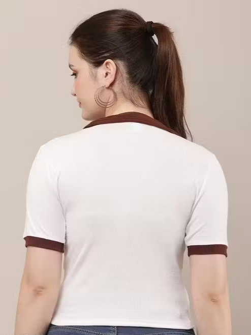 Woman wearing a white blouse with brown accents on a beige background